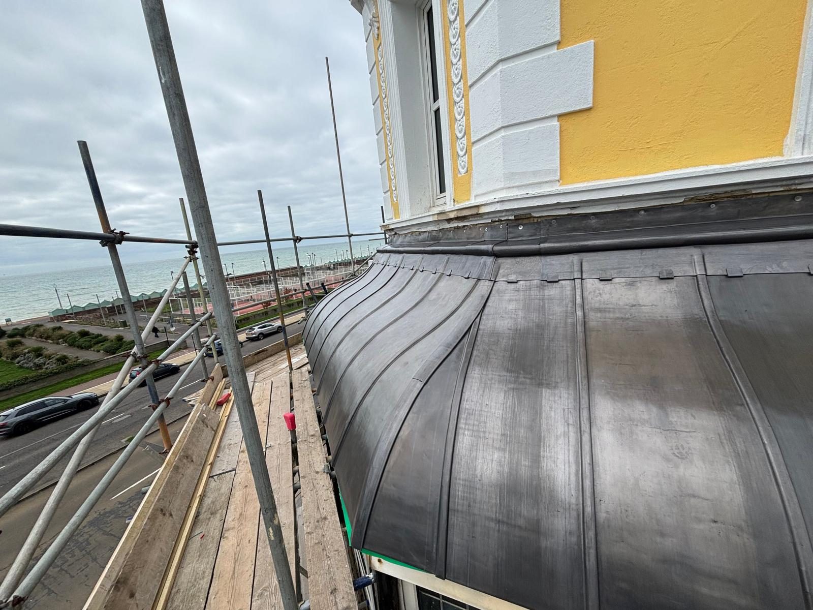 Curved lead roof with wood-roll courses overlooking the Brighton seafront